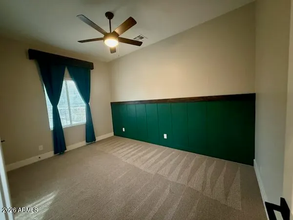 a view of a livingroom with a ceiling fan and window