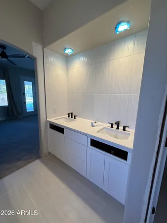 a bathroom with a tub sink and mirror