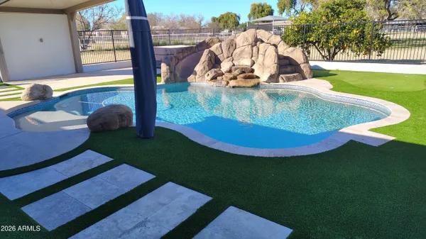 swimming pool view with a garden space