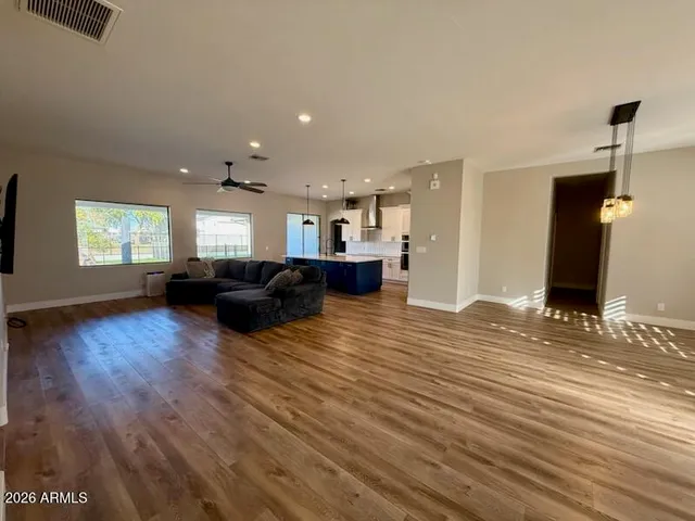 a living room with furniture and a wooden floor