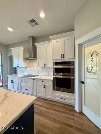 a kitchen with stainless steel appliances a stove a sink and a microwave
