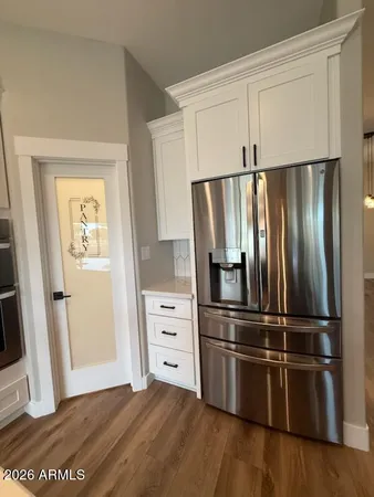a kitchen with stainless steel appliances wooden floor sink and wooden floor