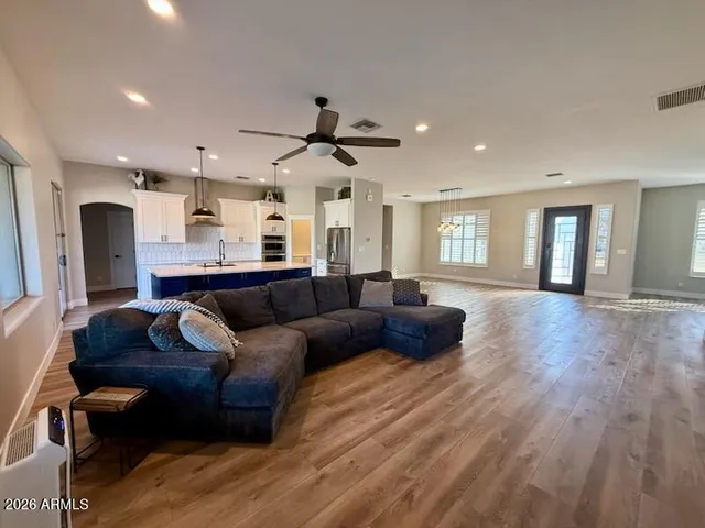 a living room with furniture and a wooden floor