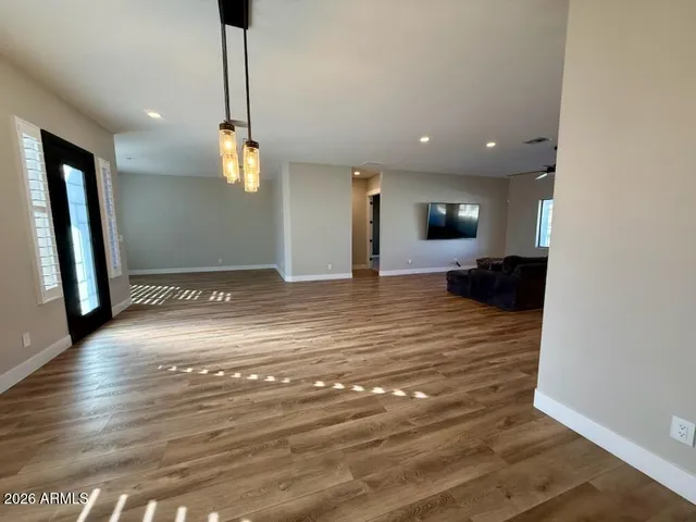 a view of a living room a kitchen and a chandelier