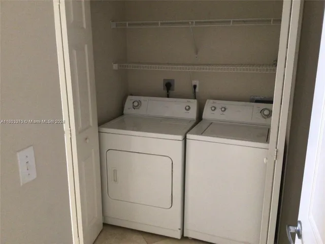 a kitchen with a refrigerator and a microwave