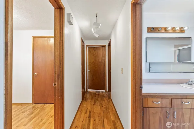 a view of a hallway with wooden floor and entryway