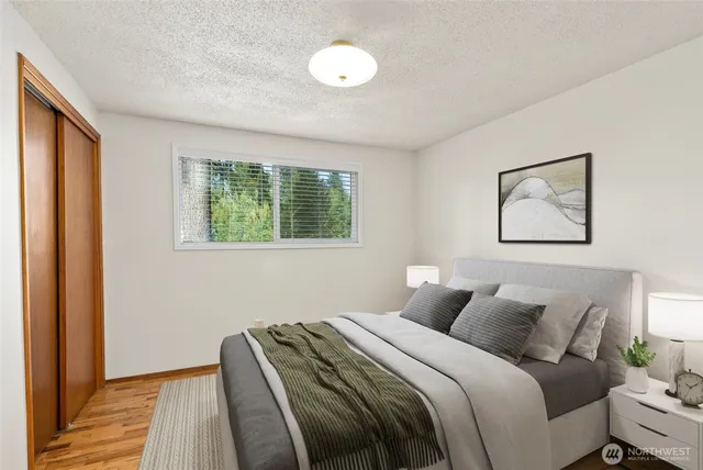 a bedroom with bed and a window