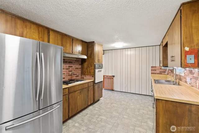 a kitchen with stainless steel appliances a refrigerator and a sink