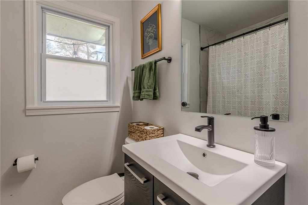 1692 Derrill Drive Decatur, GA 30032 - Photo 15 of 29 a bathroom with a sink a toilet and mirror
