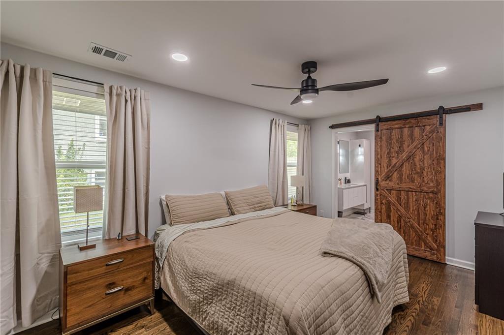 1692 Derrill Drive Decatur, GA 30032 - Photo 19 of 29 a bedroom with a bed and a chandelier