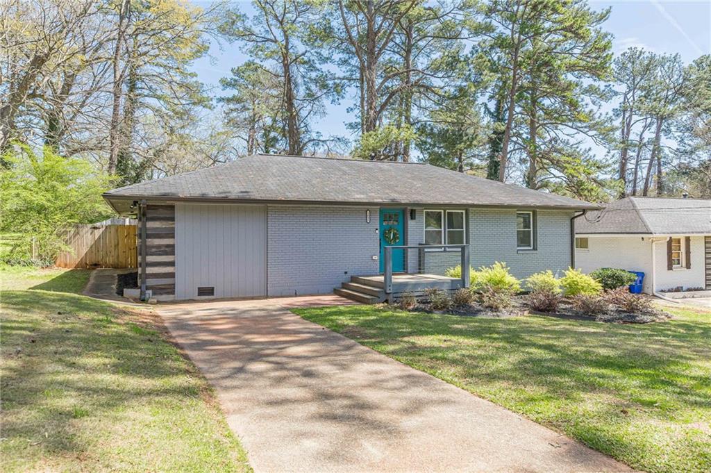 1692 Derrill Drive Decatur, GA 30032 - Photo 29 of 29 a front view of a house with a garden and trees