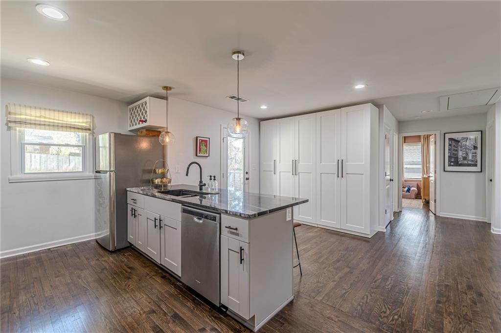 1692 Derrill Drive Decatur, GA 30032 - Photo 5 of 29 a kitchen with stainless steel appliances granite countertop a sink stove and wooden floor