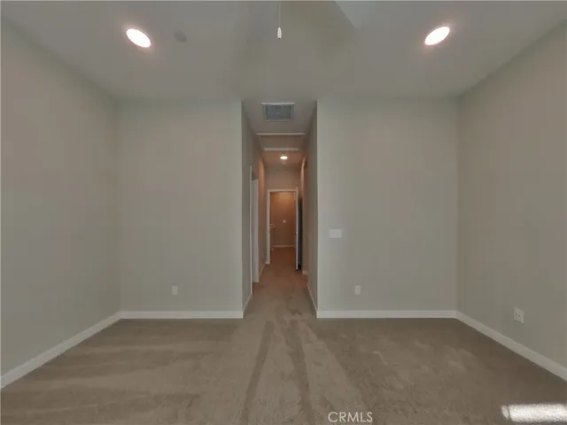 an empty room with closet and wooden door