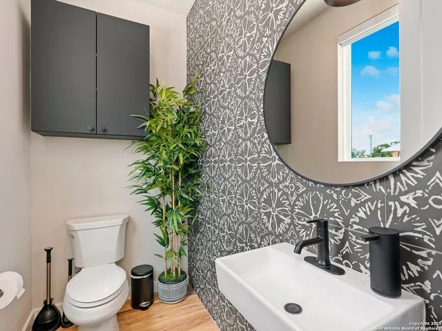 a bathroom with a toilet a sink and a mirror