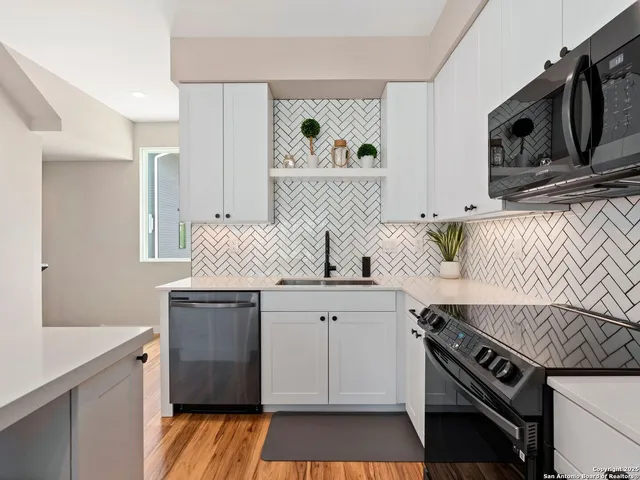 a kitchen with a sink stove and cabinets