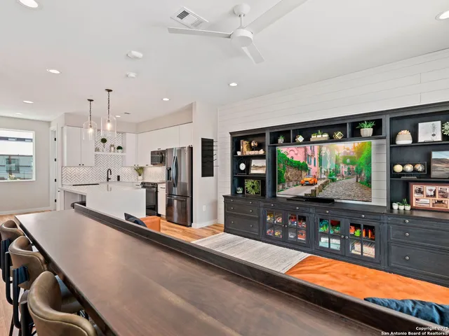 a large kitchen with stainless steel appliances lots of counter space and a refrigerator