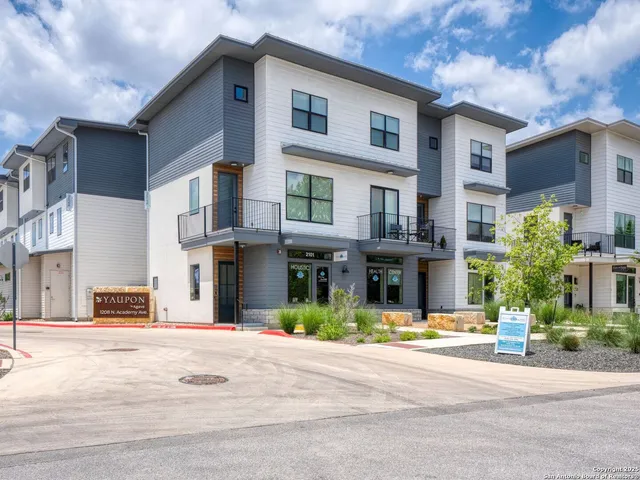 a front view of a building with small garden