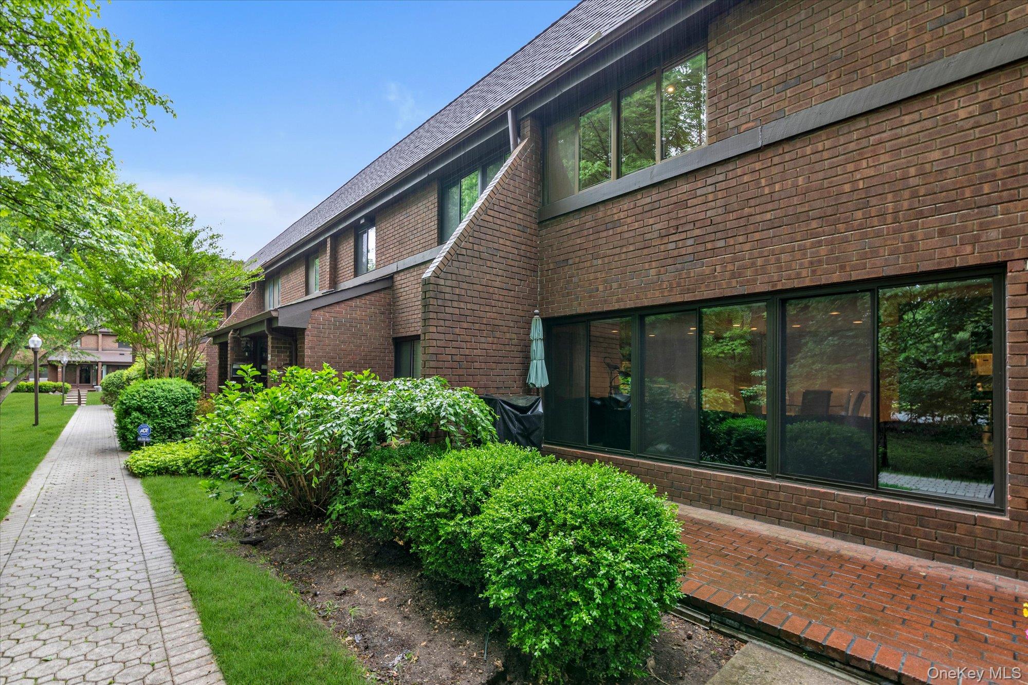 41 Spring Hollow Road Roslyn, NY 11576 - Photo 2 of 27 a front view of a house with garden