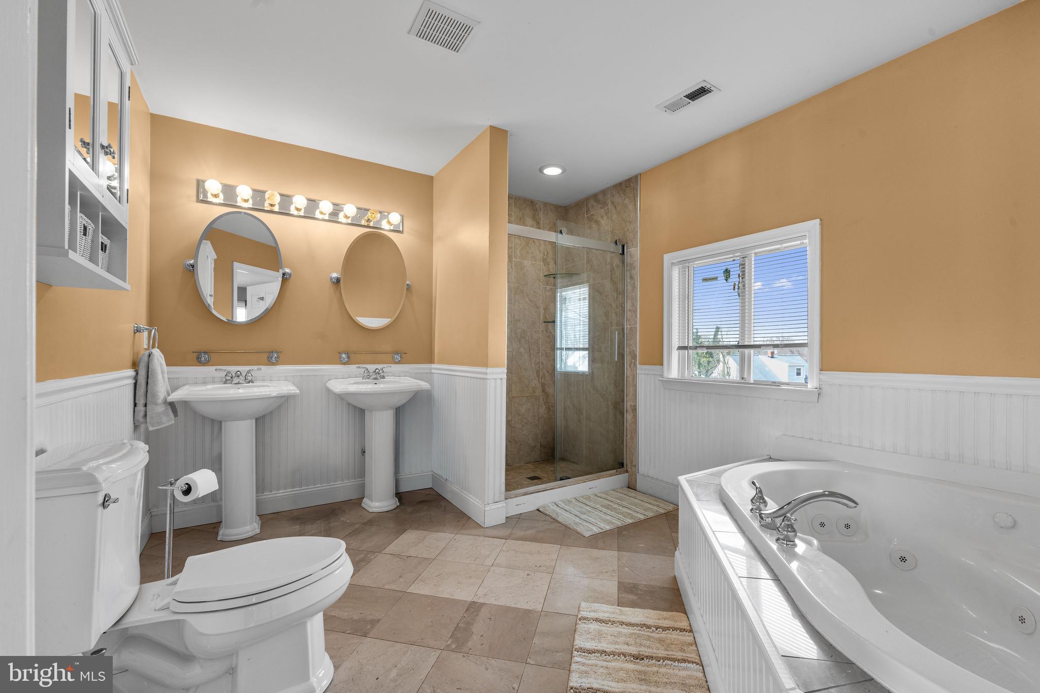 910 Hilltop Road Curtis Bay, MD 21226 - Photo 17 of 28 a bathroom with a toilet sink vanity granite tub and mirror