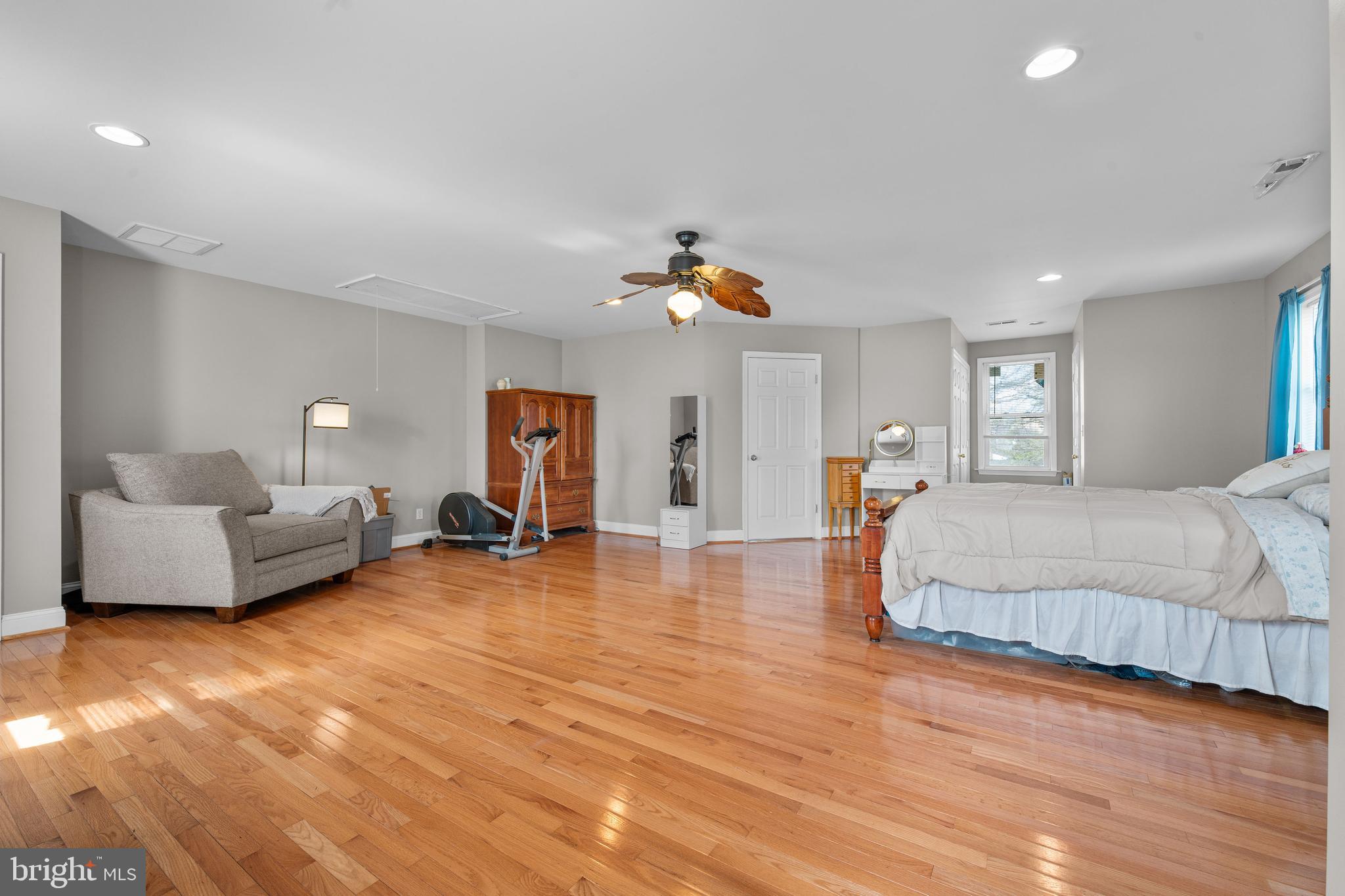 910 Hilltop Road Curtis Bay, MD 21226 - Photo 18 of 28 a spacious bedroom with a bed and a couch