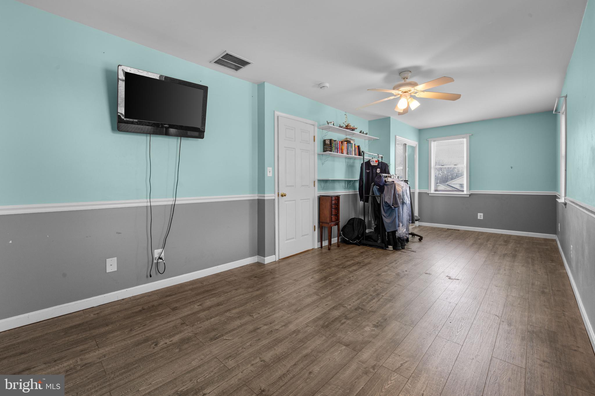 910 Hilltop Road Curtis Bay, MD 21226 - Photo 20 of 28 a view of a room with wooden floor and a flat screen tv