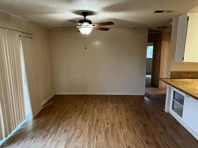 wooden floor in an empty room with a mirror