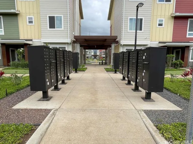 a black and white building with trees in front of it