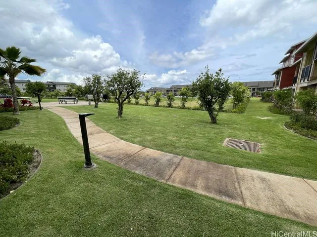 a view of a sign board with potted plants