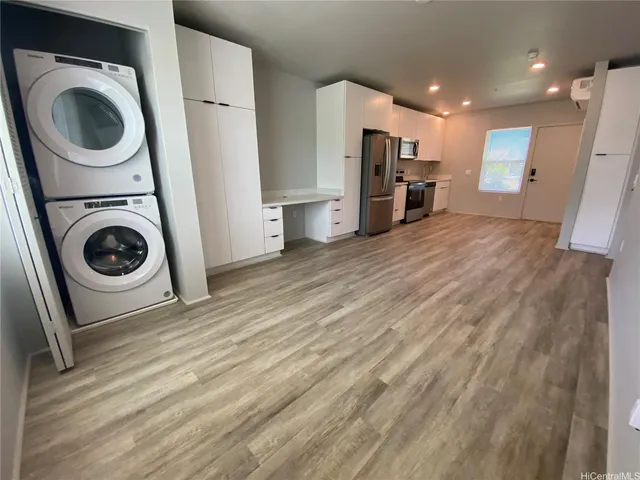 a view of a kitchen with a washer and dryer