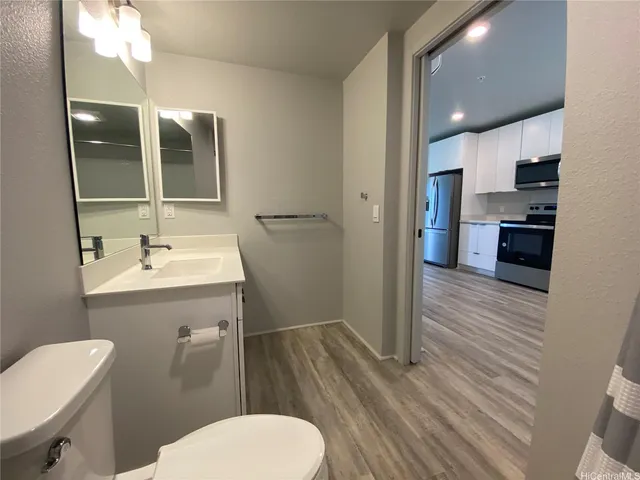 a bathroom with a toilet sink and mirror