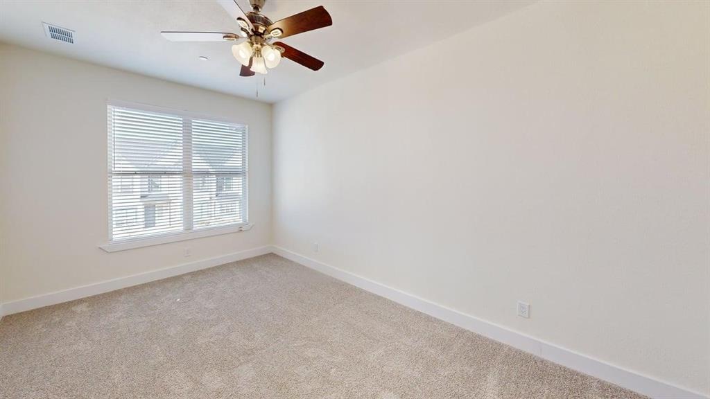 353 Buck Ridge Drive Little Elm, TX 75068 - Photo 11 of 23 Unfurnished room featuring light colored carpet and a ceiling fan