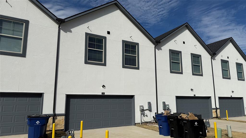 353 Buck Ridge Drive Little Elm, TX 75068 - Photo 23 of 23 View of property exterior featuring a garage, stucco siding, and driveway