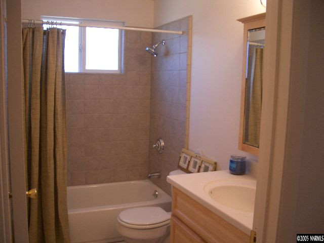 13905 Chamy Drive Reno, NV 89521 - Photo 6 of 9 a bathroom with a granite countertop sink toilet and shower