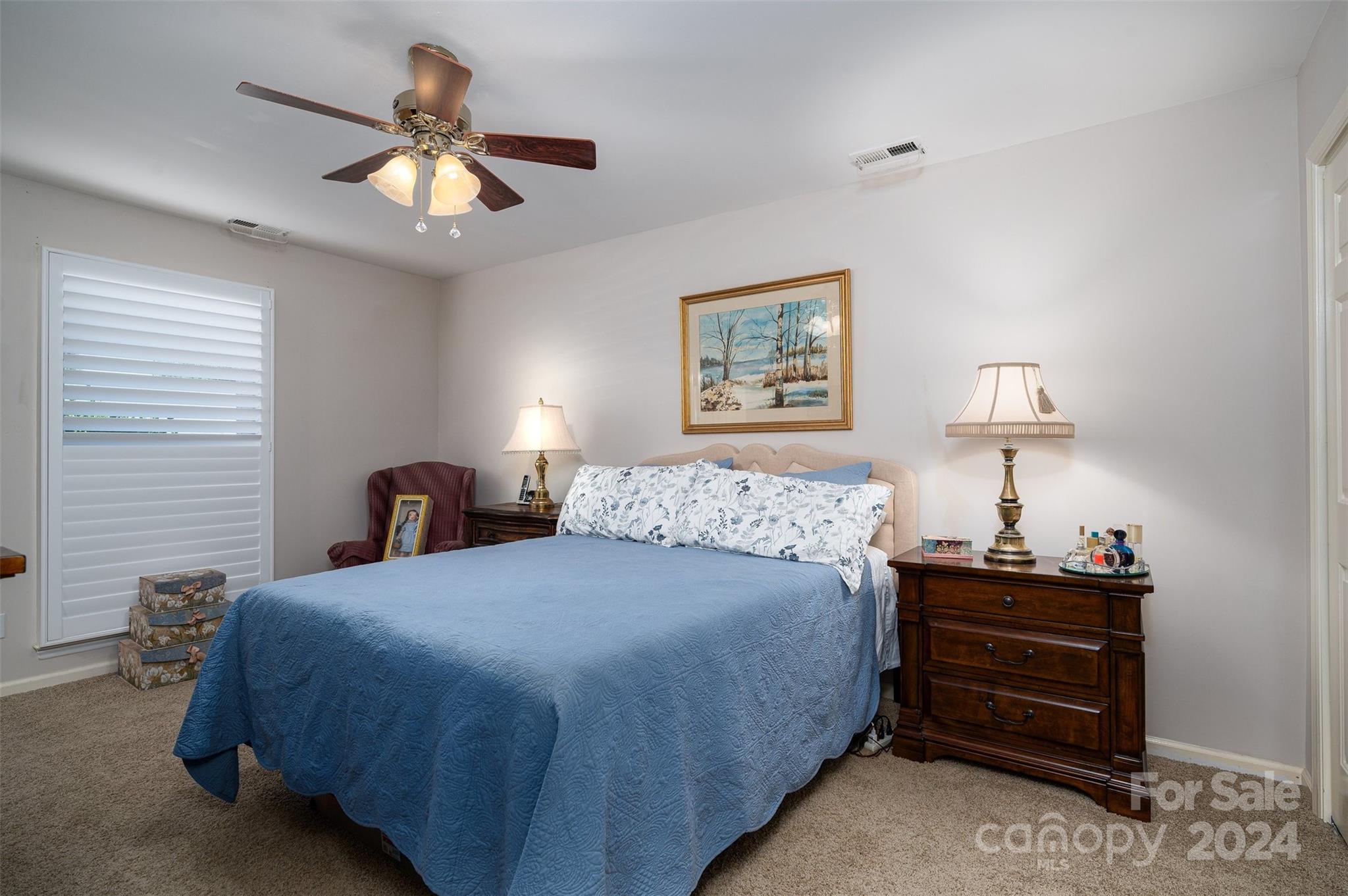 2009 Union Road, Unit E Gastonia, NC 28054 - Photo 12 of 17 a bedroom with a bed and a chandelier