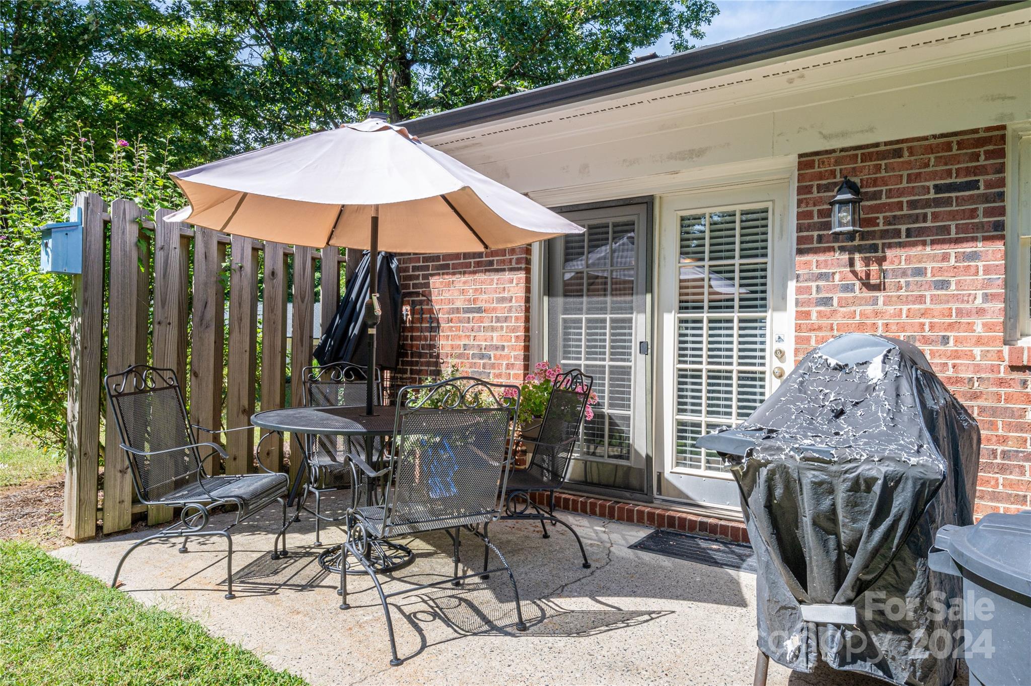 2009 Union Road, Unit E Gastonia, NC 28054 - Photo 15 of 17 a view of a patio with a table and chairs under an umbrella