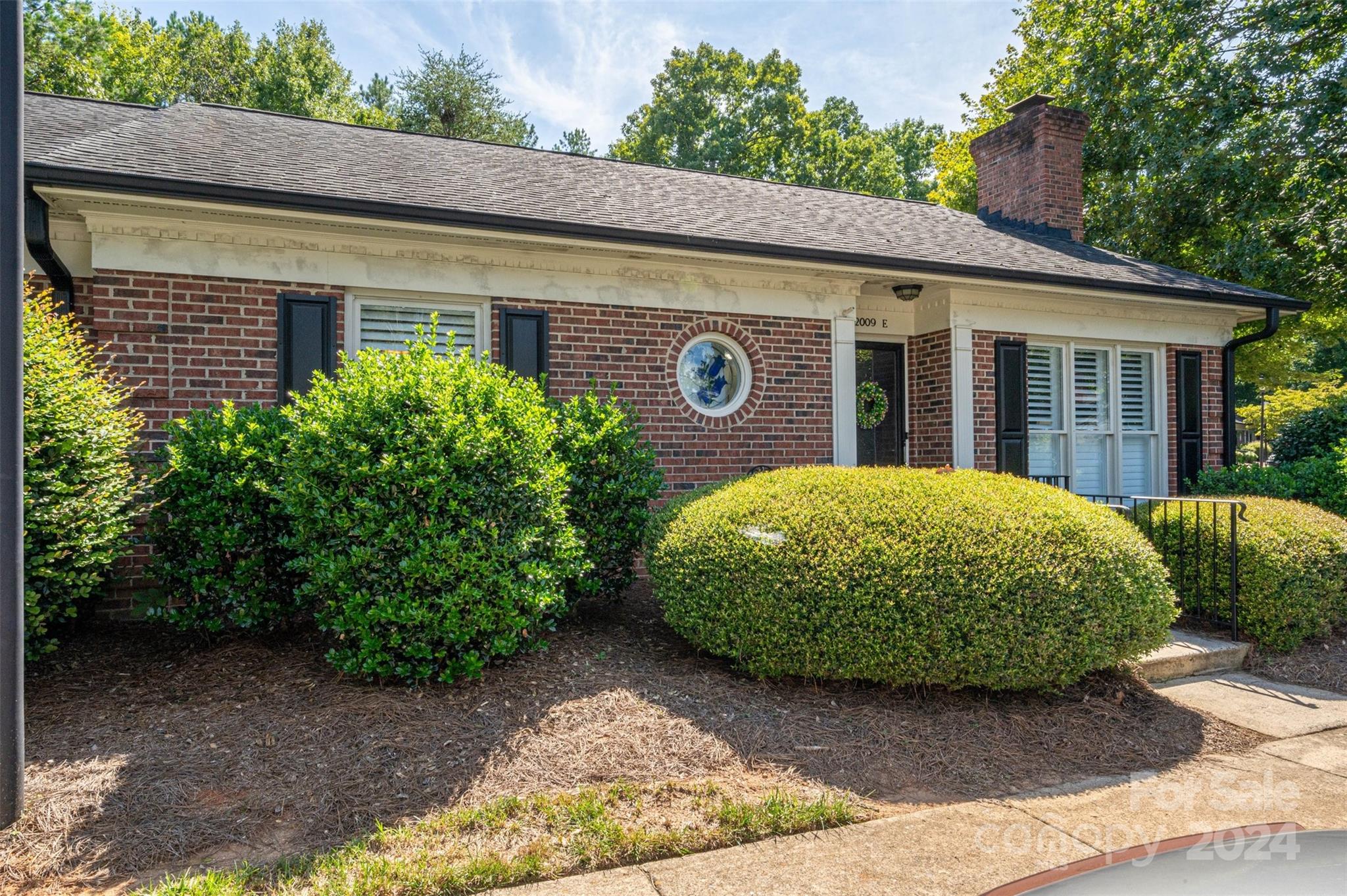 2009 Union Road, Unit E Gastonia, NC 28054 - Photo 2 of 17 a view of a house with a small yard plants and large tree