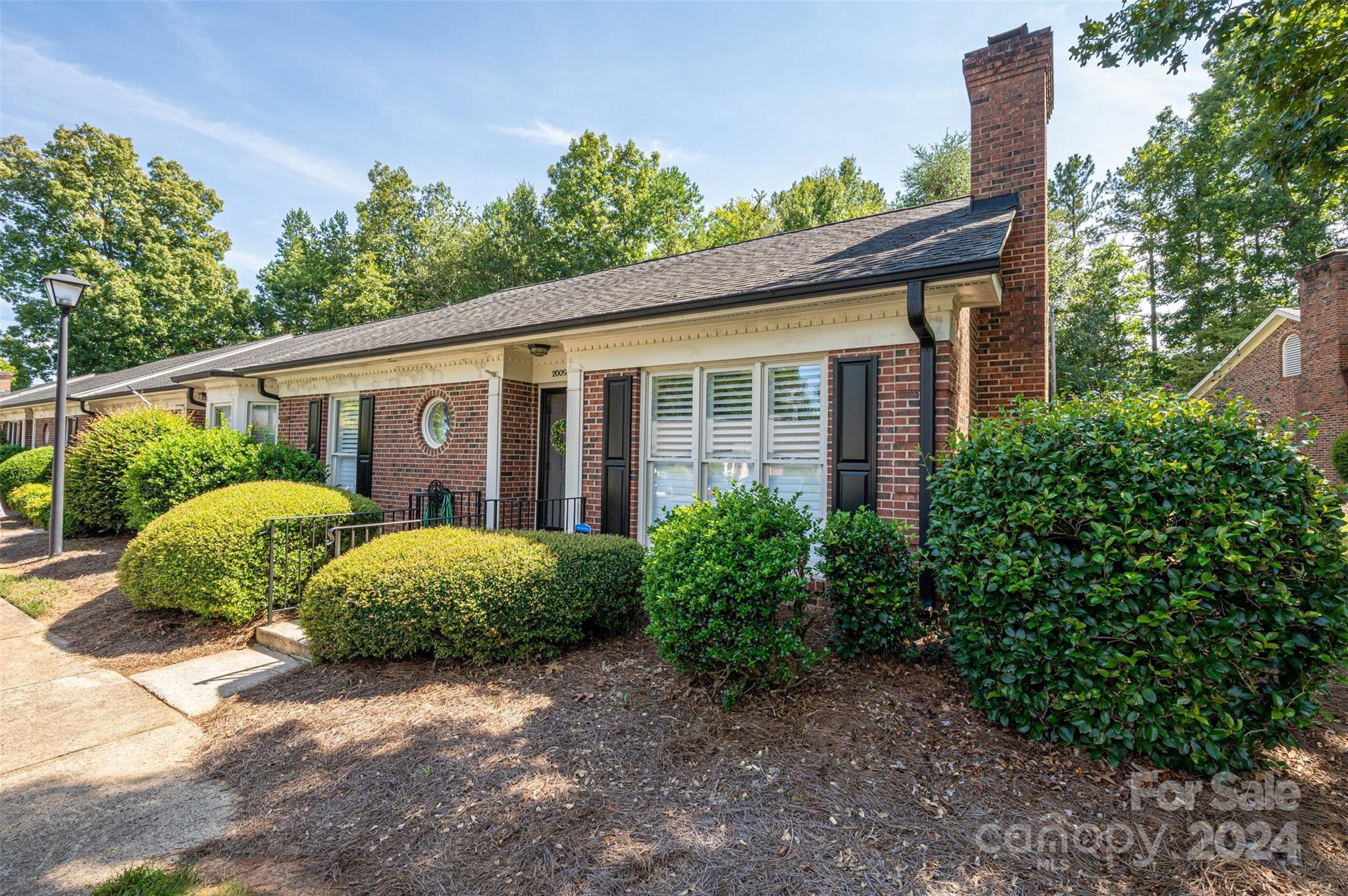 2009 Union Road, Unit E Gastonia, NC 28054 - Photo 3 of 17 a view of a house with a small yard and plants