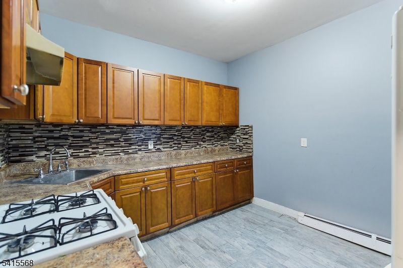 a kitchen with granite countertop a stove and a sink