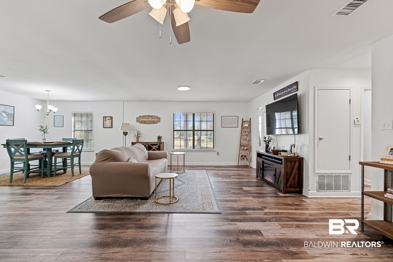 6801 Piney Woods Road Foley, AL 36535 - Photo 34 of 74 Living area with dark wood-style floors, ceiling fan, and a chandelier