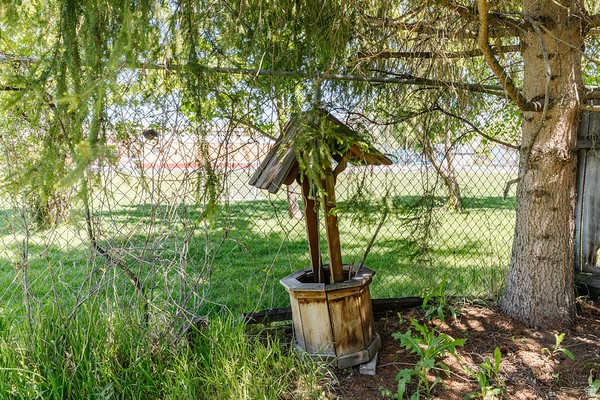 365 West 200 North Logan, UT 84321 - Photo 38 of 45 Fenced yard area featuring a decorative wooden wishing well