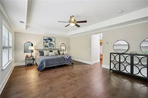 a bedroom with a bed furniture and wooden floor