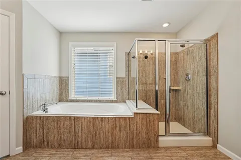 a bathroom with a bathtub and a shower