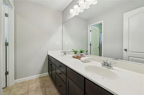 a bathroom with a double vanity sink and a mirror