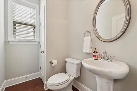 a bathroom with a sink a toilet and a mirror