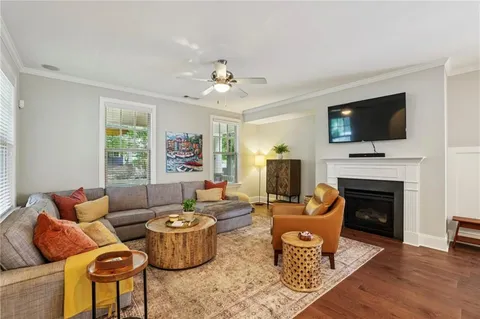 a living room with furniture a flat screen tv and a fireplace
