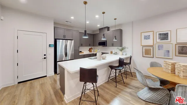 a large kitchen with a table and chairs