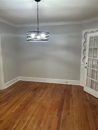 a view of a room with wooden floor and window