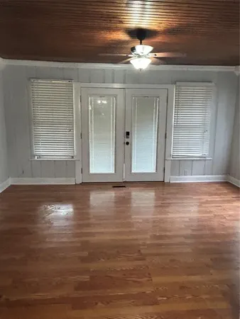 a view of room with window and wooden floor