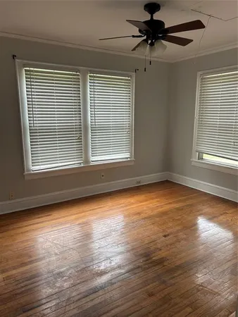 a view of a room with wooden floor and a window