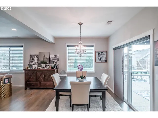 a living room with fireplace furniture and a chandelier